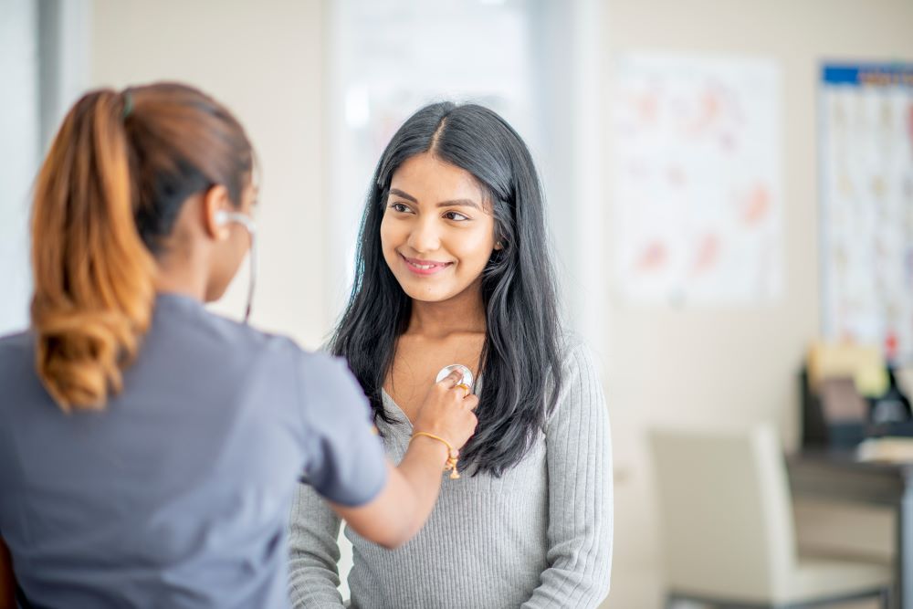 Patient smiling in doctor's office.